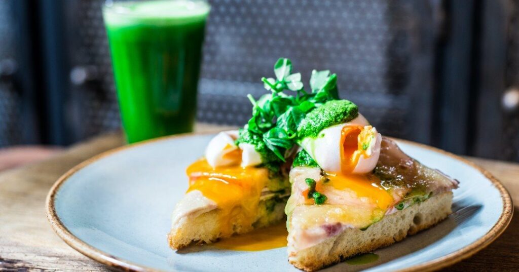 Poached eggs on toast with herbs and a green juice from the Antipodea brunch menu