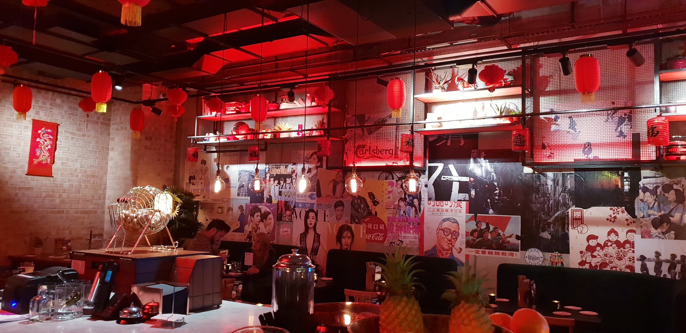 The Bao & Bing dining room with red lanterns, vintage posters and the bar beyond
