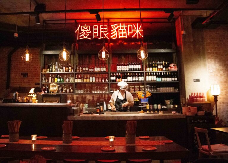 The bar at Bao & Bing in Marylebone, under red neon Taiwanese characters