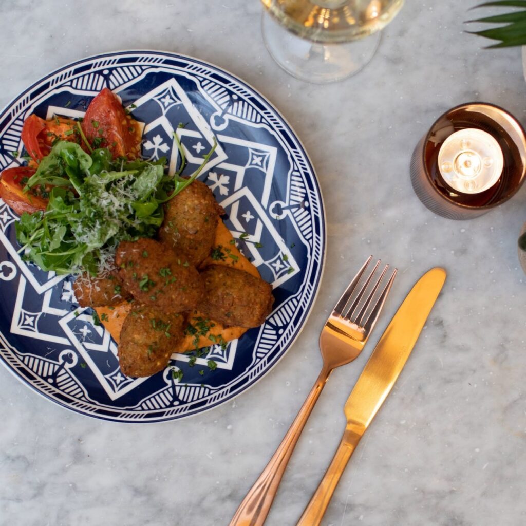 Falafel and salad on a blue and white patterned plate
