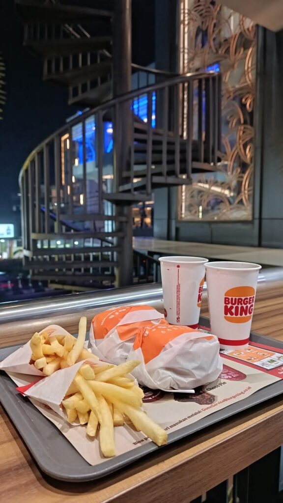 A Burger King meal on a tray, with fries and drinks