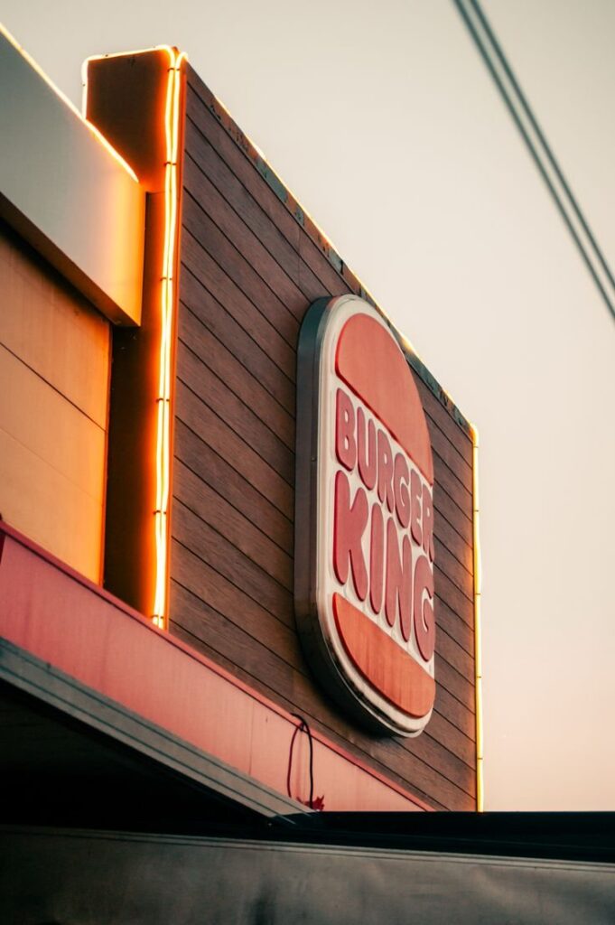 Burger King signage on a restaurant facade at dusk