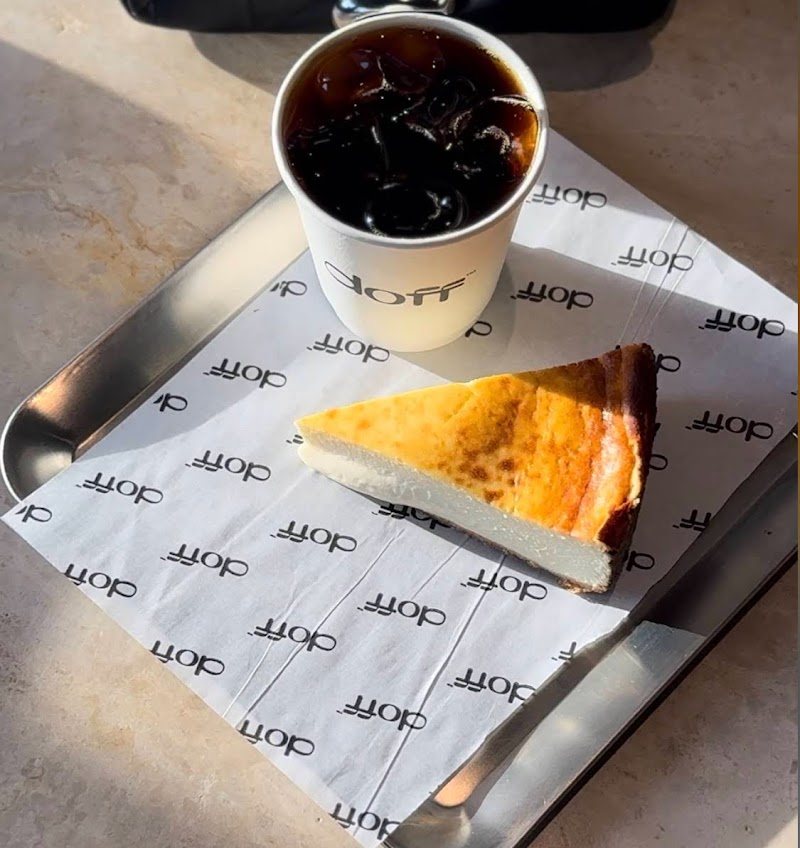Basque cheesecake and an iced coffee on Doff branded paper