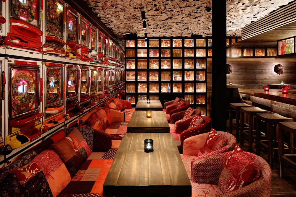 Red velvet banquettes beneath a textured ceiling at ICHIBUNS