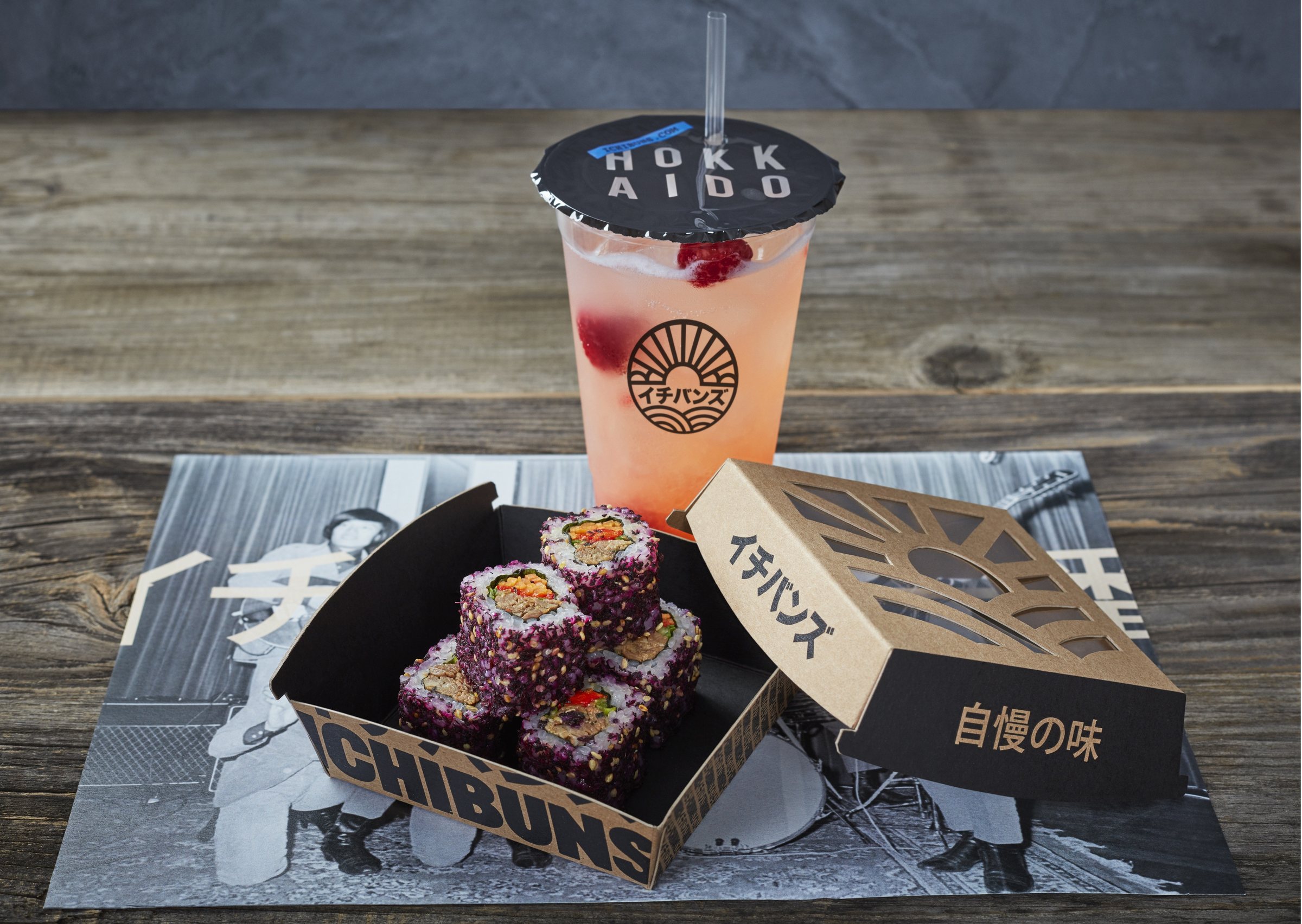 Purple rice sushi rolls in a branded ICHIBUNS box with a soft drink