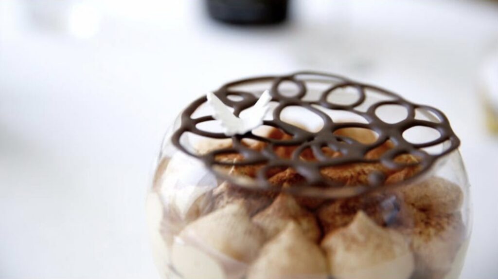 A chocolate lattice dessert in a glass