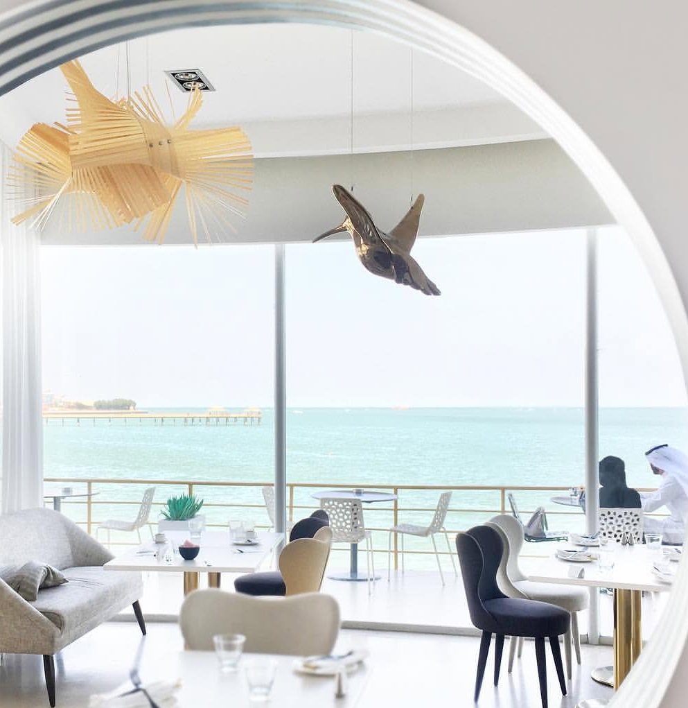 The bright seafront salon at Lenôtre Kuwait, framed by a round window