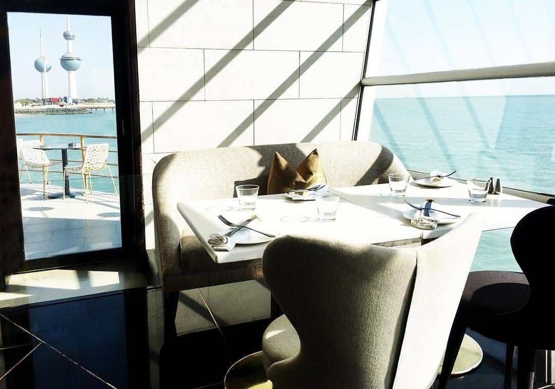 The Lenôtre dining room in Kuwait City, with the Kuwait Towers visible through the window