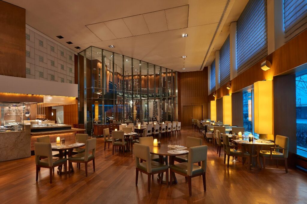 The parkhuus restaurant at Park Hyatt Zurich, with its glass wine library and double-height windows