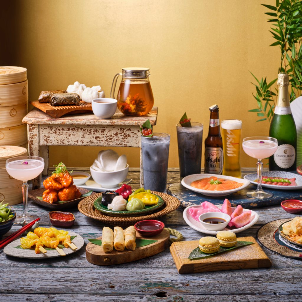Dim sum, cocktails and tea laid out along a table
