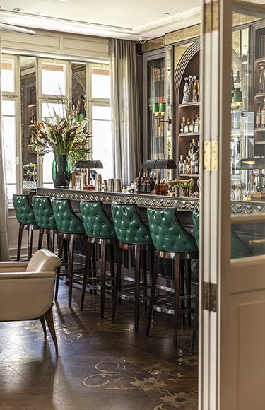 The Library Bar at The Norman, with green leather bar stools